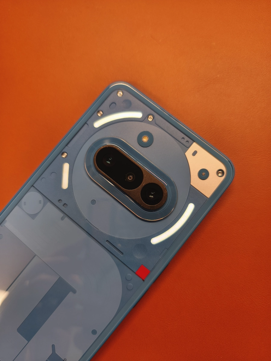 Nothing Phone (3a)ブルー限定色の透明背面とLED Glyphライト、50MPトリプルカメラモジュールを強調したクローズアップ写真