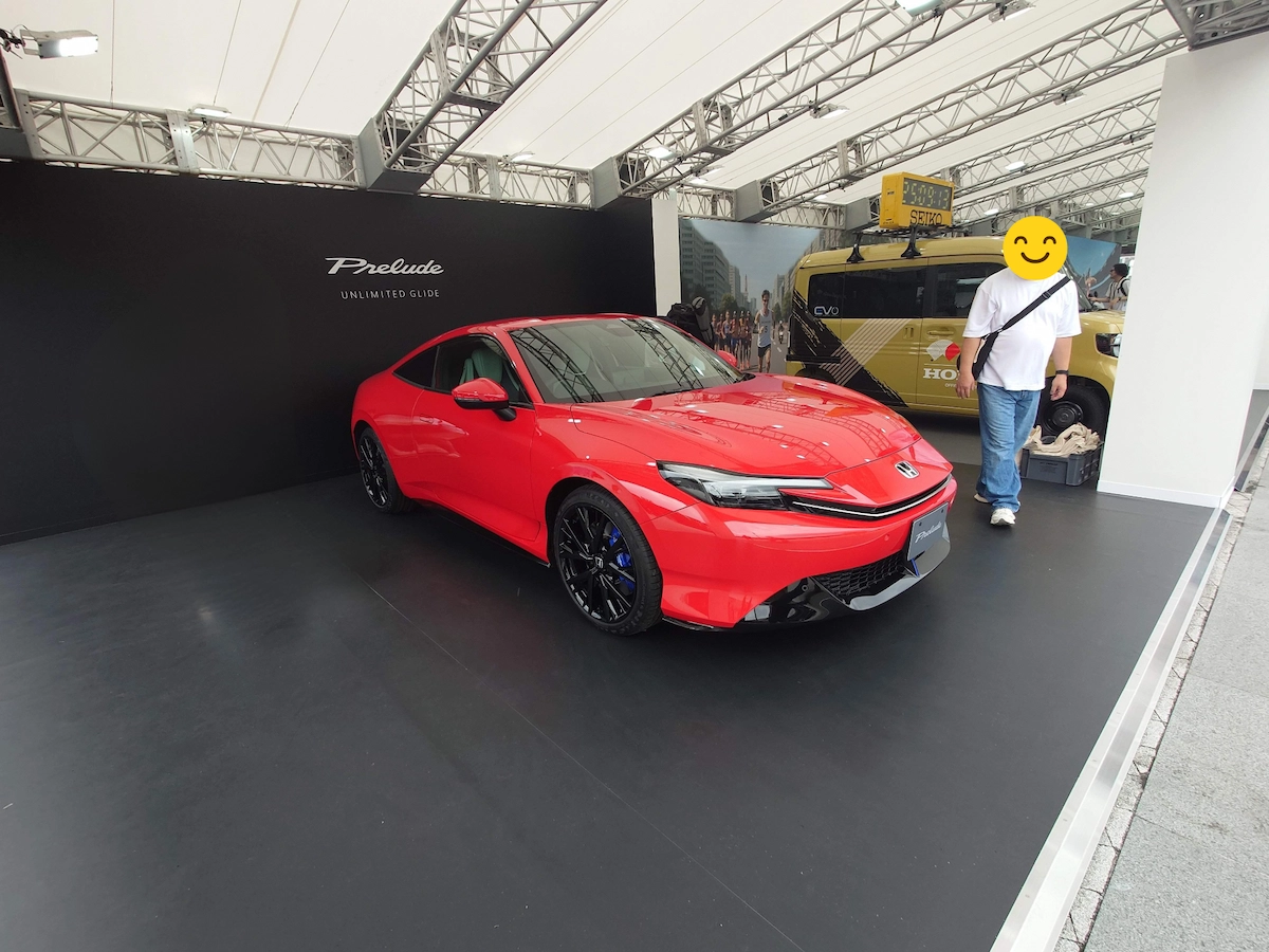 赤いホンダ・プレリュードを展示会場で撮影。黒の展示ブース背景に映えるクーペスタイルの新型車